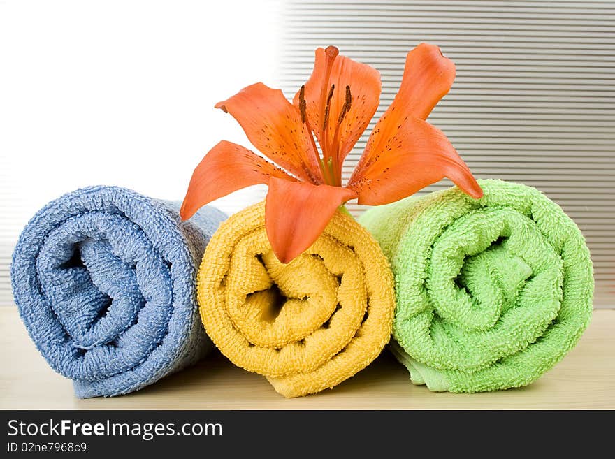 Colored towels are folded to lie next to them flower tiger lily. Colored towels are folded to lie next to them flower tiger lily