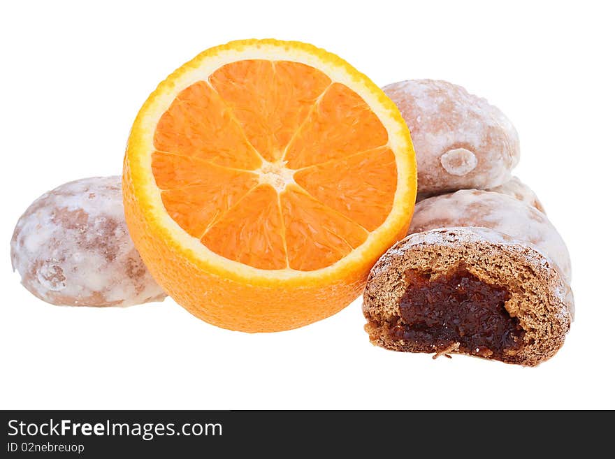 Easy dessert - sweet spice-cakes and an orange on a white background.