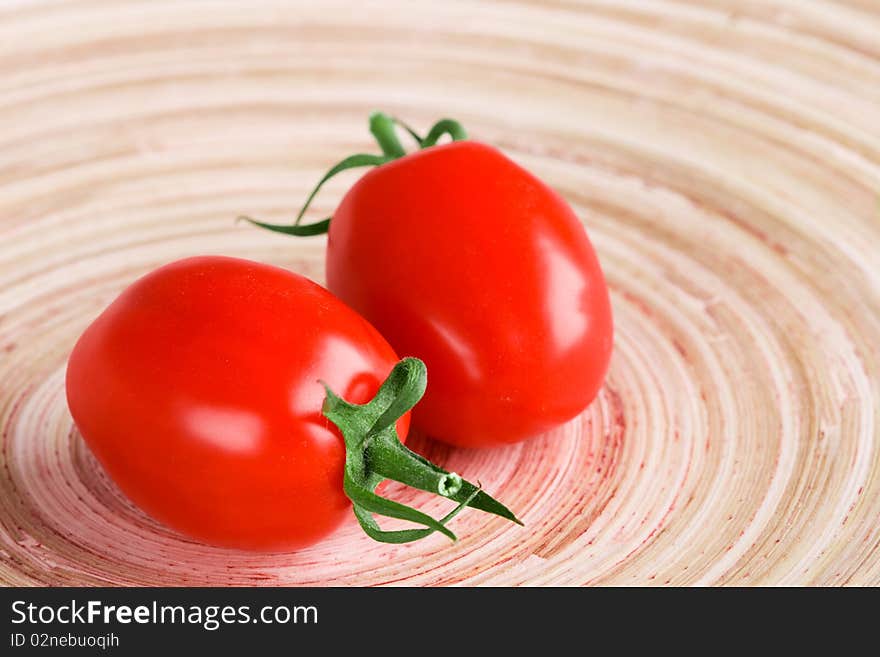 Two tomatoes closeup on wooden table