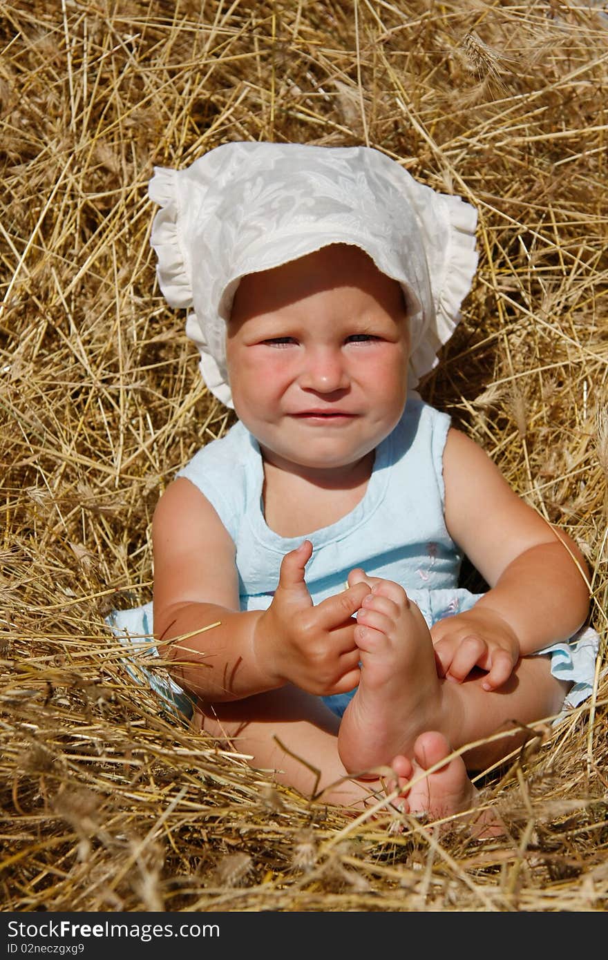 Toddler girl in hay