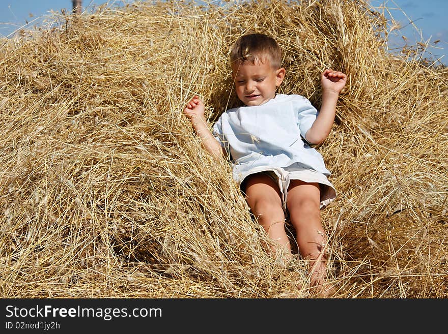 Boy playing in hay