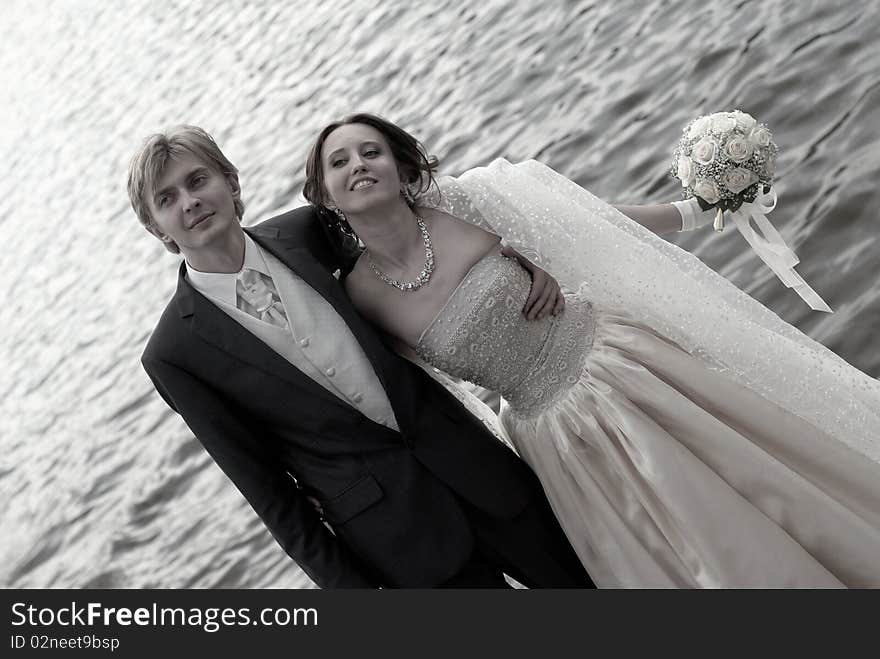 Happy bride and groom on the coast