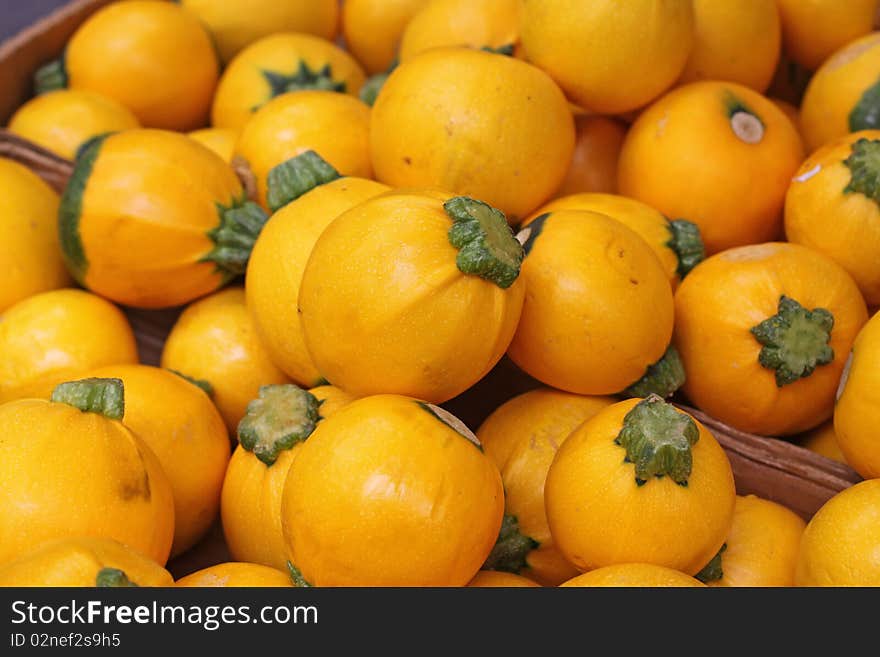 Small yellow squashes at farmers market.