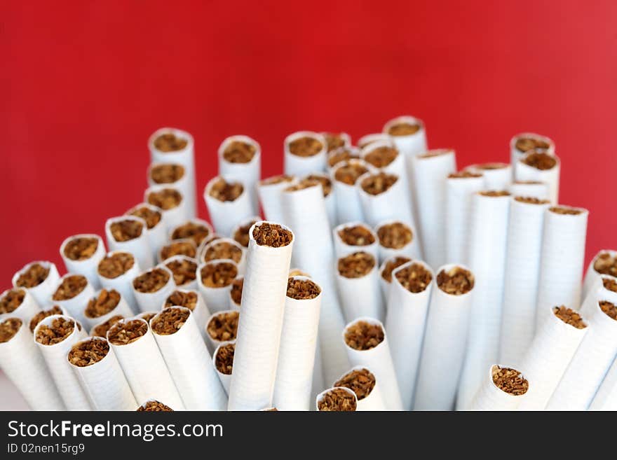 A lot of cigarettes on red background