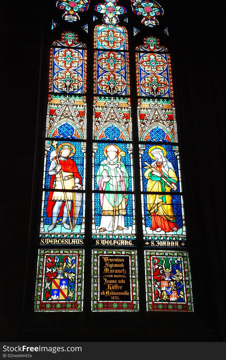 Gothic stained glass window in St. Vitus cathedral in Prague portraying the Pentecost