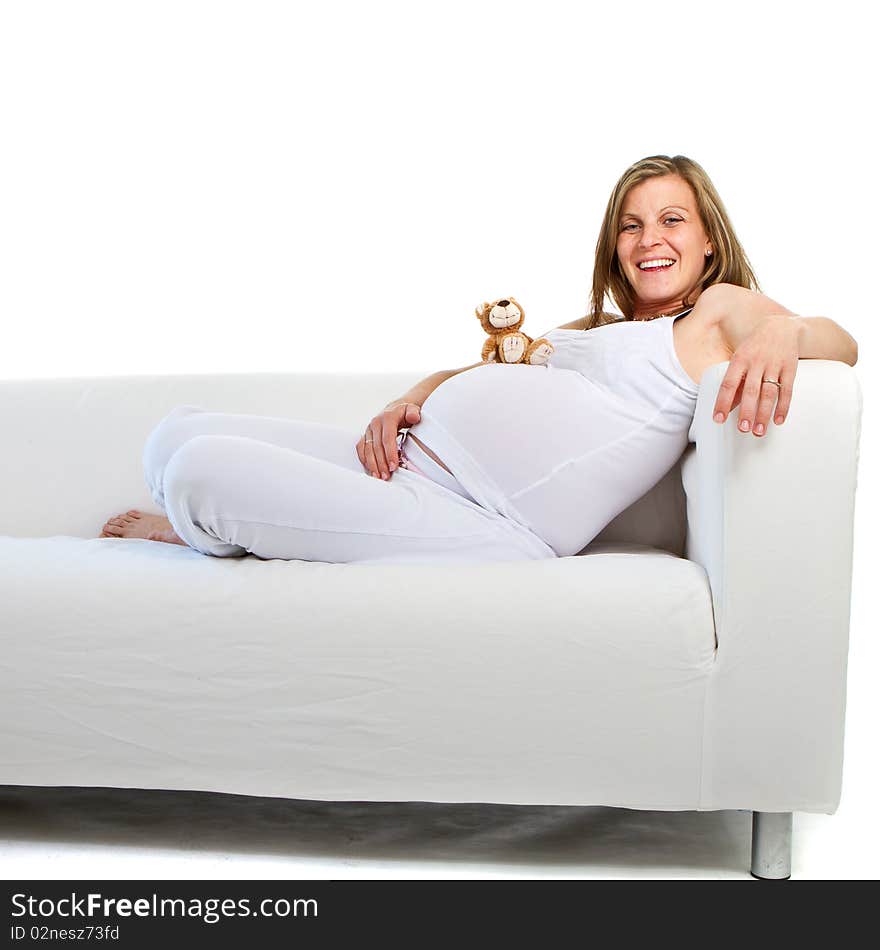 Young fresh pregnant woman with baby toys. Isolated over white background. Young fresh pregnant woman with baby toys. Isolated over white background.