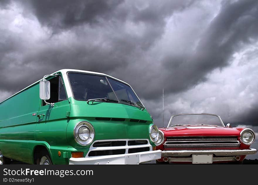 Classic van and car against cloudy sky background. Classic van and car against cloudy sky background