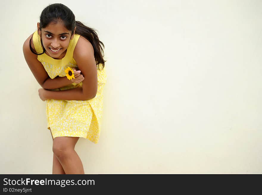 Indian beautiful girl posing at outdoor yellow wall. Indian beautiful girl posing at outdoor yellow wall