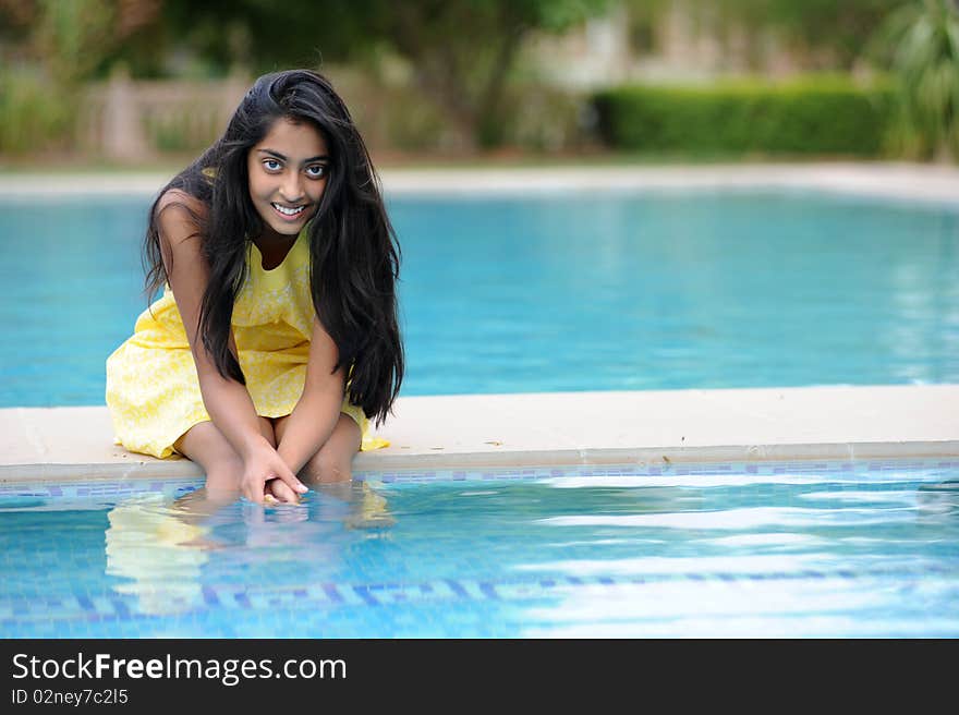 Girl sitting at pool