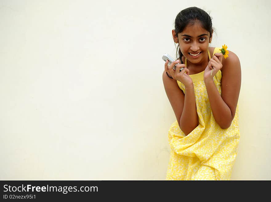 Indian beautiful girl posing at outdoor yellow wall. Indian beautiful girl posing at outdoor yellow wall