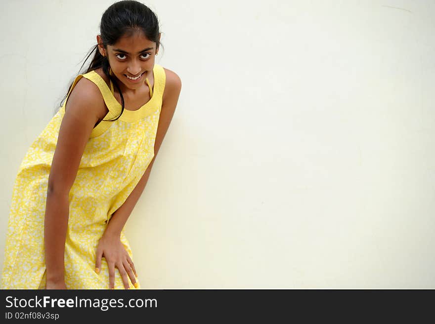 Indian beautiful girl posing at outdoor yellow wall. Indian beautiful girl posing at outdoor yellow wall