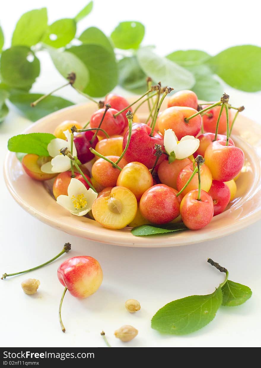 A cup of cherry with flower on light background