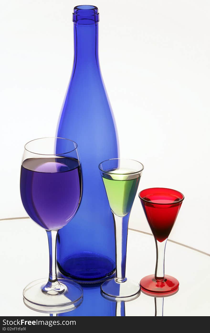 Dark Blue Bottle And Three Wine-glasses