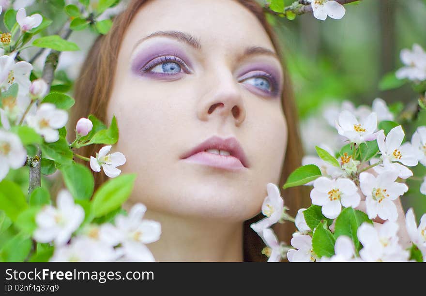 Portrait of young girl in the apple orchard