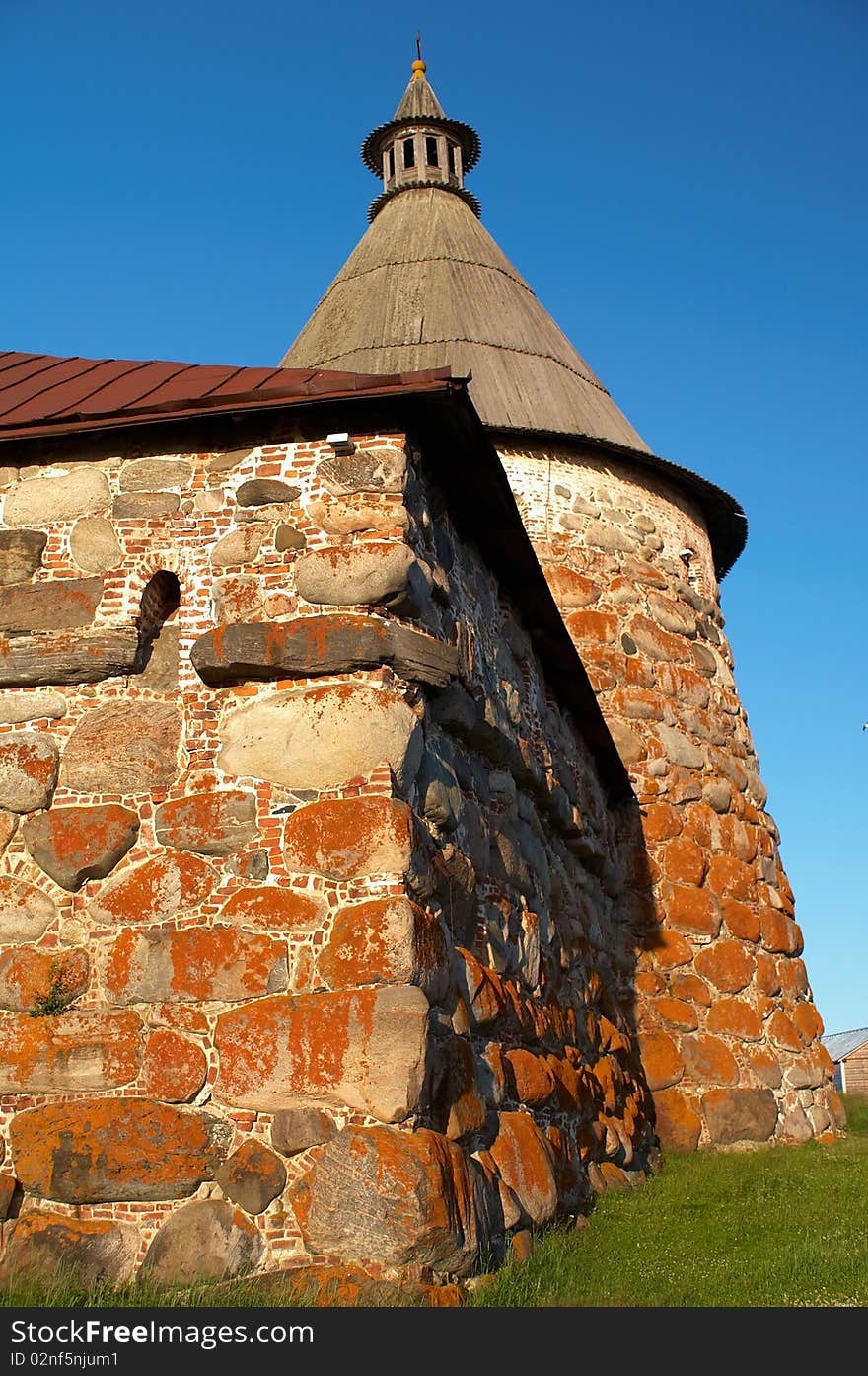 Old round stone tower in Solovetsky monastery with blue sky background, Karelia, Russian Federation. Old round stone tower in Solovetsky monastery with blue sky background, Karelia, Russian Federation.