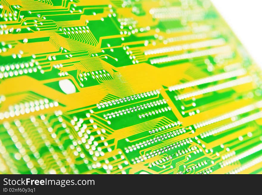 Close-up photo of circuit board in yellow and green.