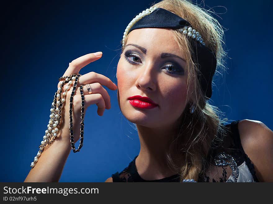 Portrait of attractive retro-style girl in bonnet over black