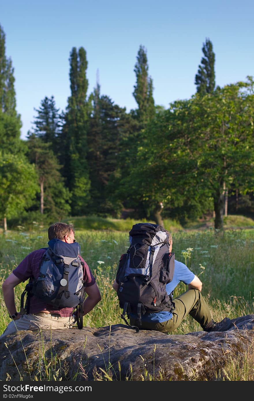 Backpackers in sunny field