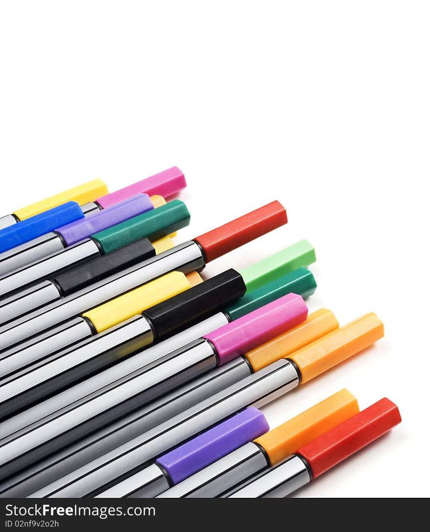 Colourful pens on a white background with space for text