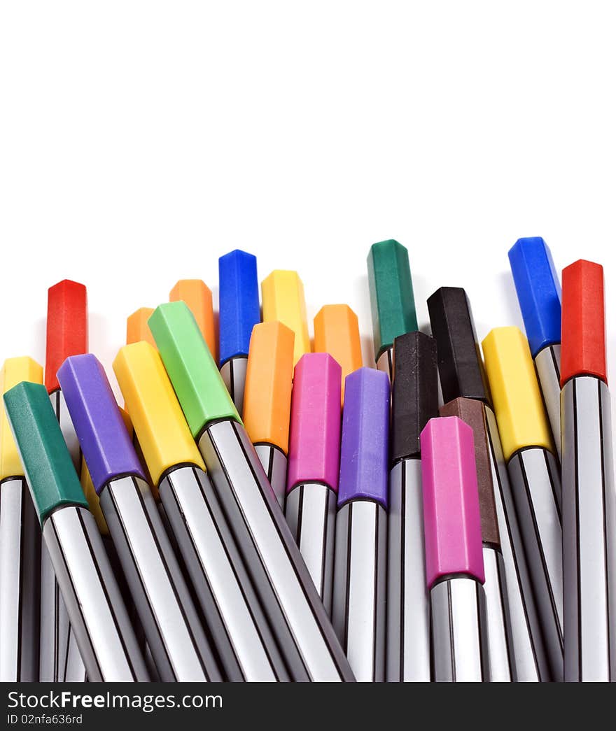 Colourful pens on a white background with space for text