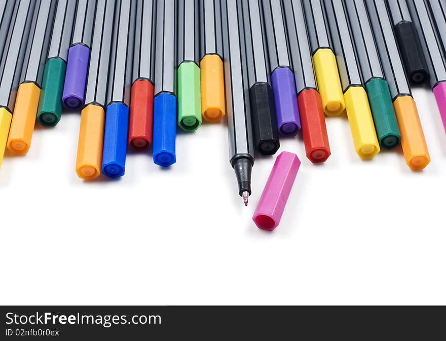 Colourful pens on a white background with space for text