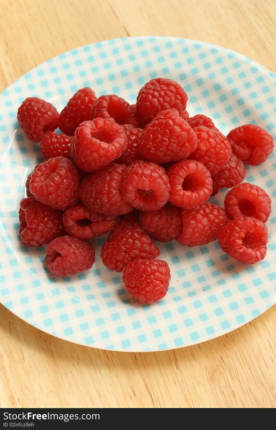 Raspberries on a patterned plate. Raspberries on a patterned plate