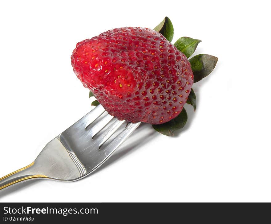 Strawberry with a fork .Eating strawberry