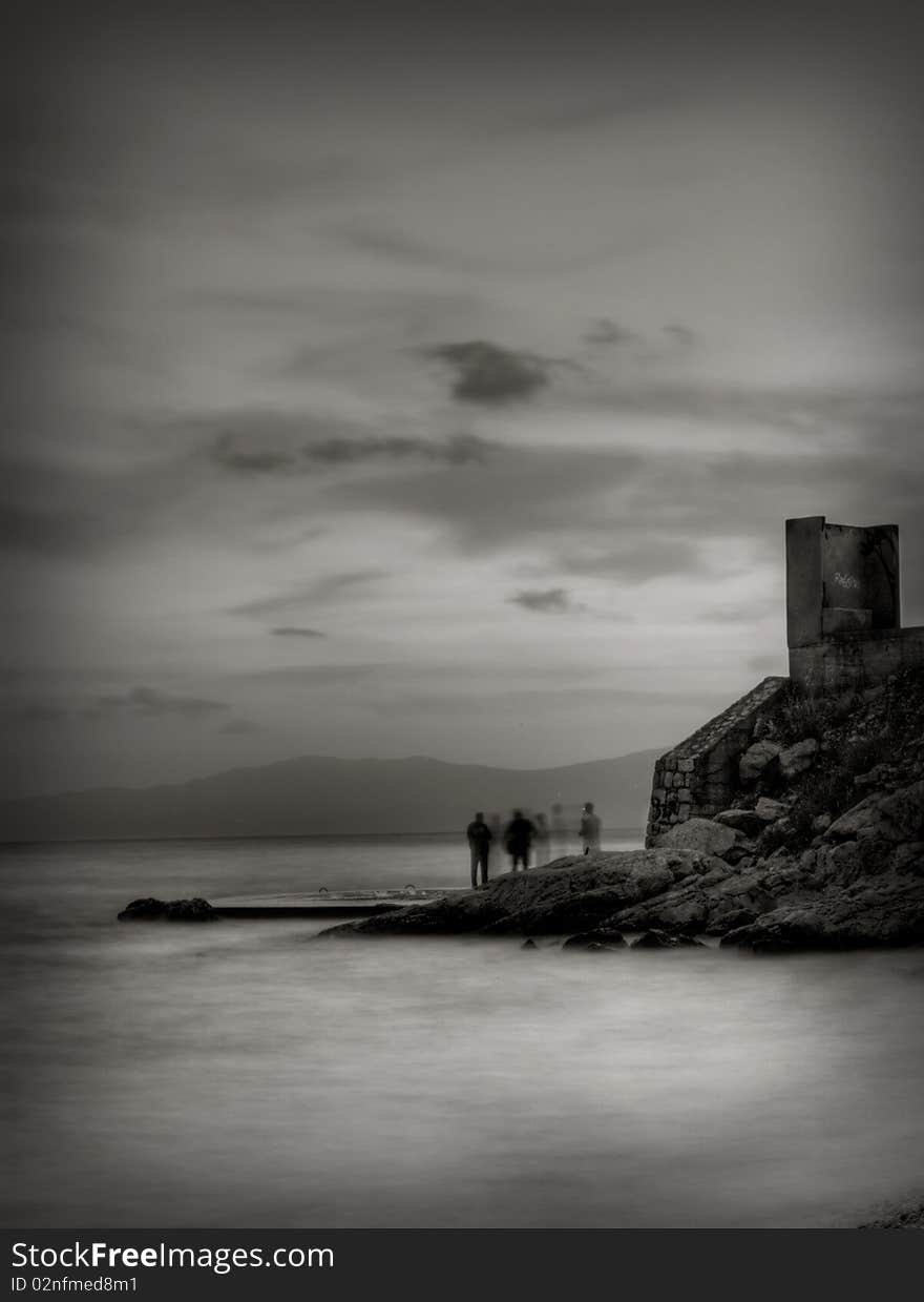 Long exposure with people talking on the sea