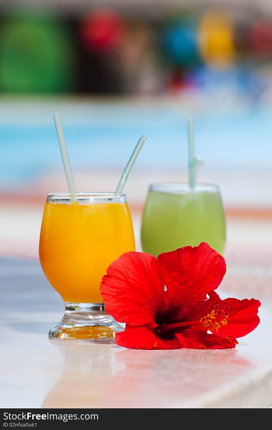 Two tropical cocktails on a table