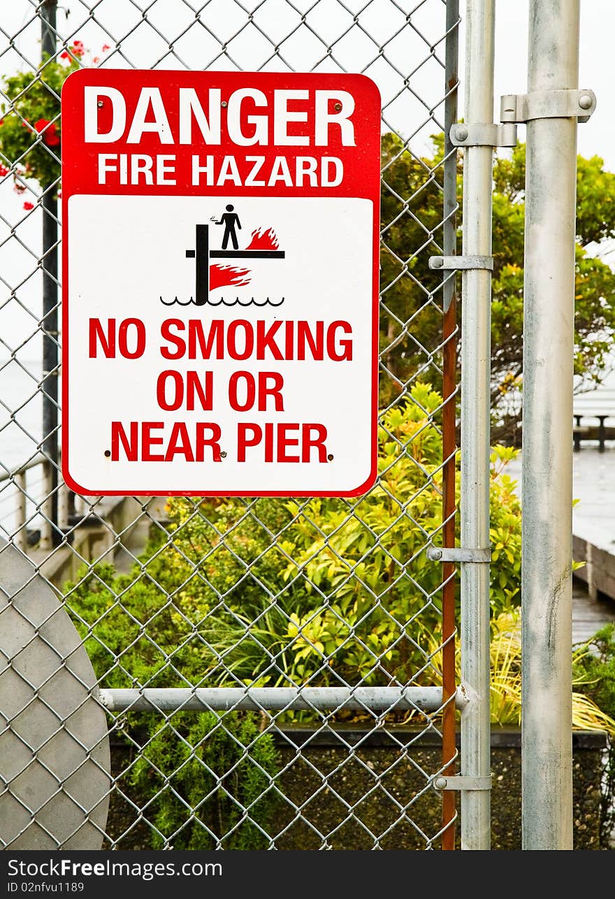 Fire Hazard sign warning people not to smoke on or near the pier. Fire Hazard sign warning people not to smoke on or near the pier