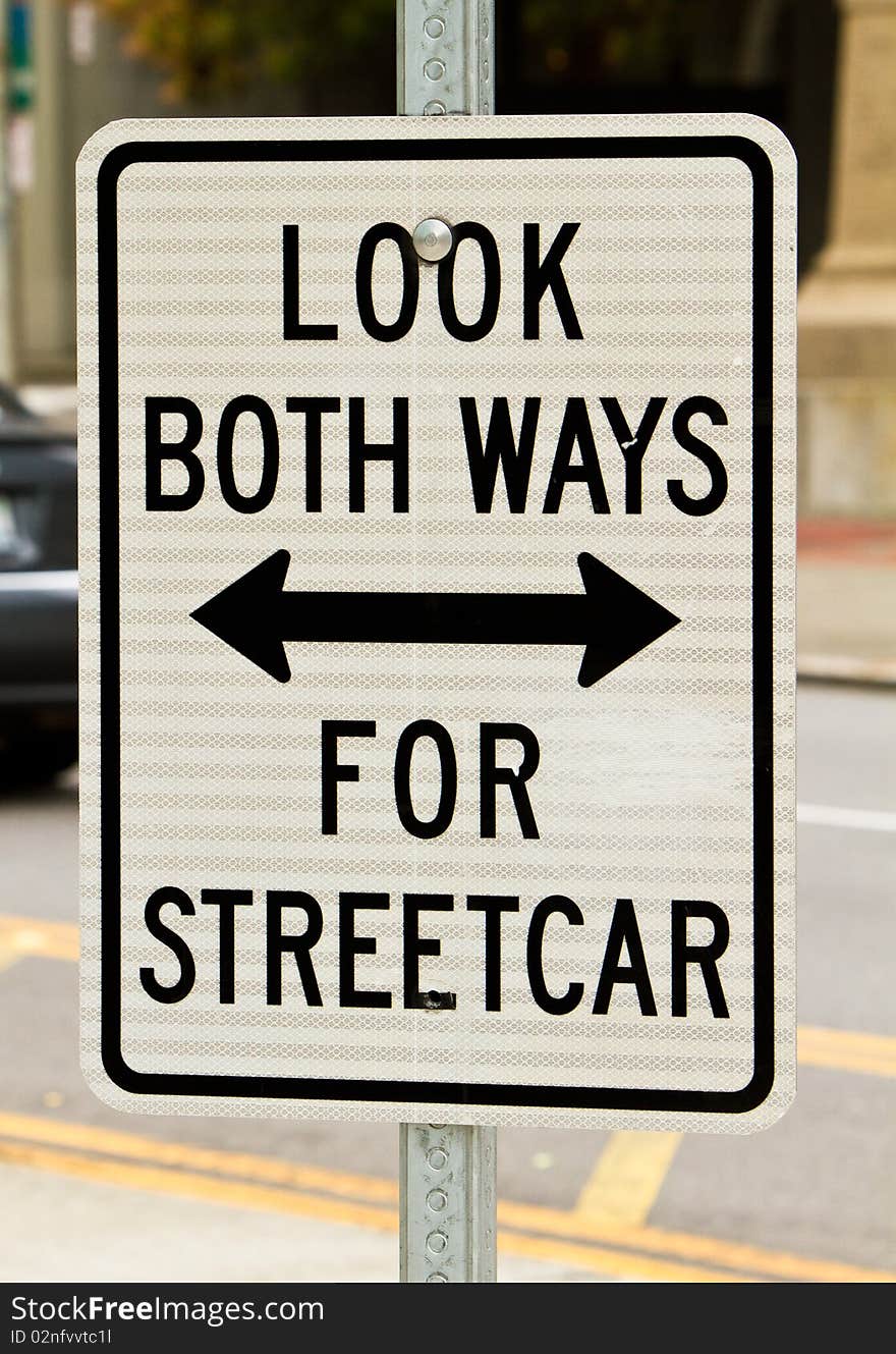 Sign warning pedestrians to look out for the streetcar. Sign warning pedestrians to look out for the streetcar