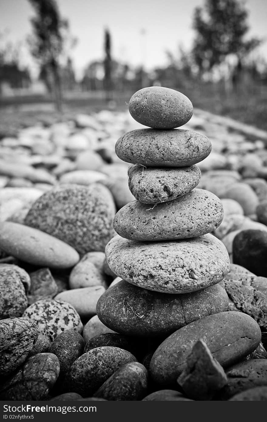 A B&W image of smooth river stones stacked on top of each other. A B&W image of smooth river stones stacked on top of each other