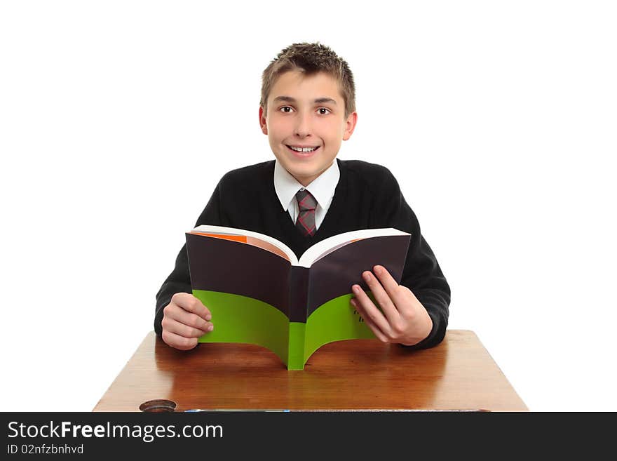 Happy smiling high school student sitting at a desk with a textbook.  White background. Happy smiling high school student sitting at a desk with a textbook.  White background.