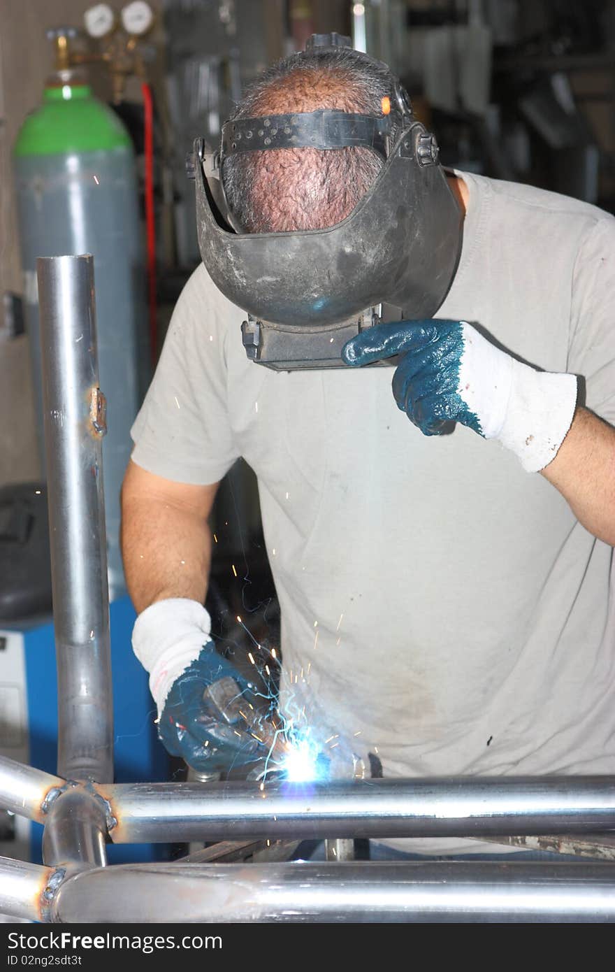 A man welding in a workshop. A man welding in a workshop