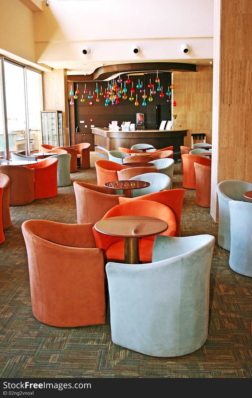 Bar interior with armchairs and marble tables. Bar interior with armchairs and marble tables.