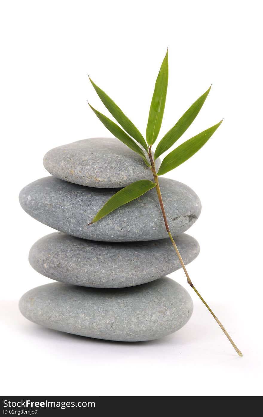 Balanced stones with bamboo leaf on white. Balanced stones with bamboo leaf on white