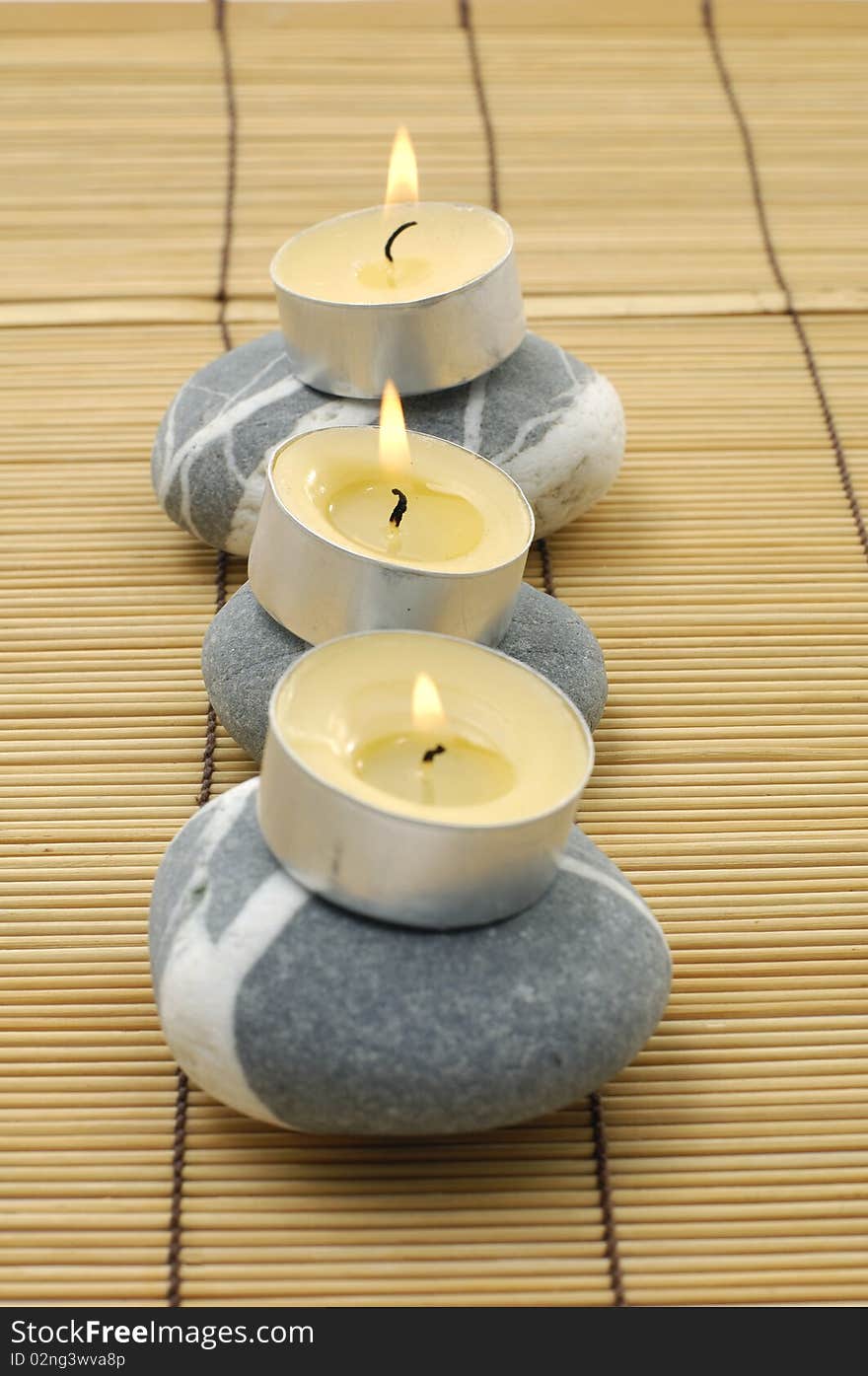 Three light candles and three stones. Three light candles and three stones