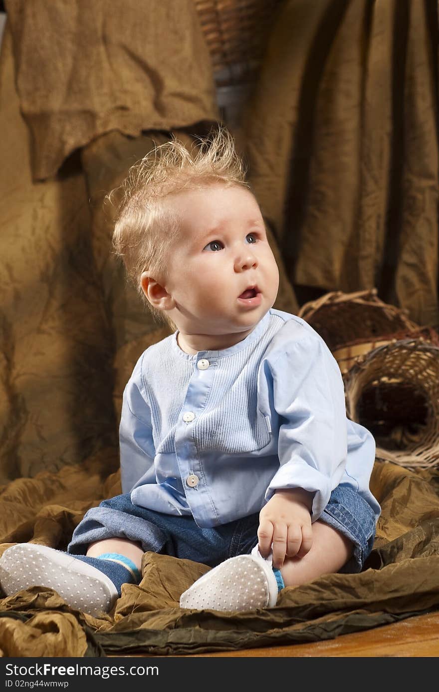 Close up of smiling baby sitting on a floor. Close up of smiling baby sitting on a floor