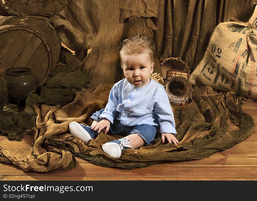 Close up of cute baby sitting on a floor. Close up of cute baby sitting on a floor