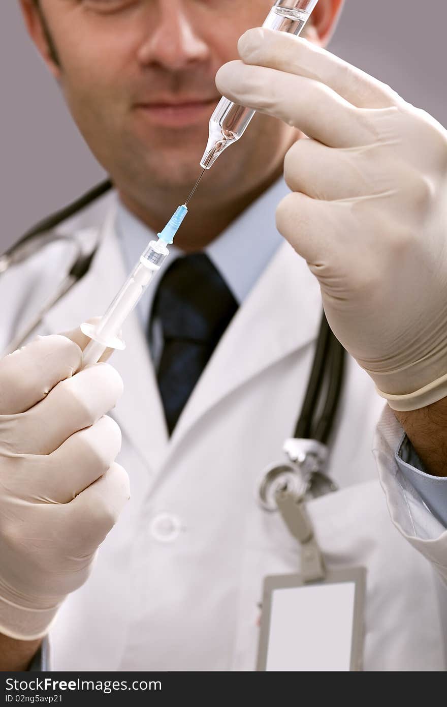 Professional doctor with medical syringe in hands, getting ready for injection