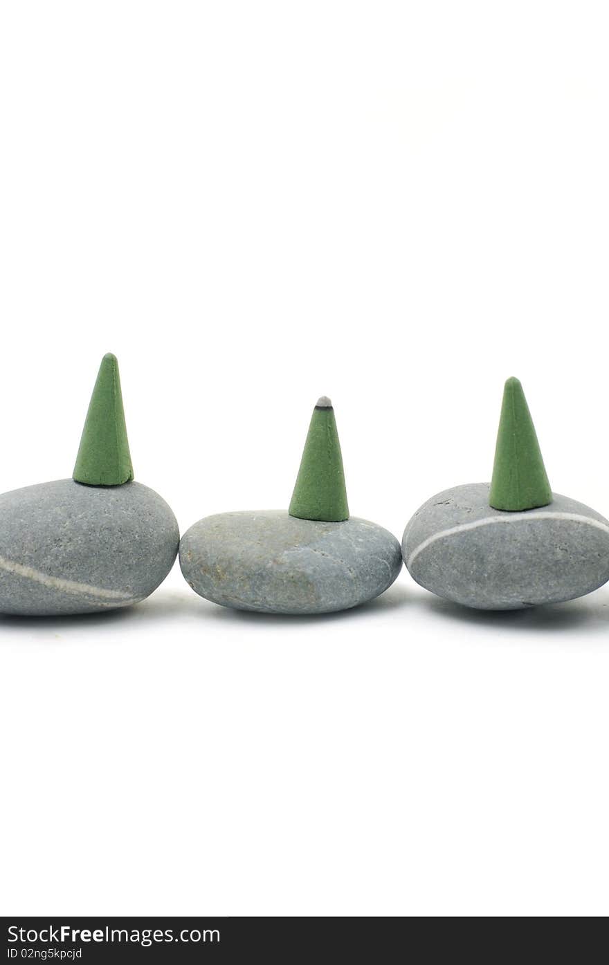 Green Incense cones on gray stones. Green Incense cones on gray stones