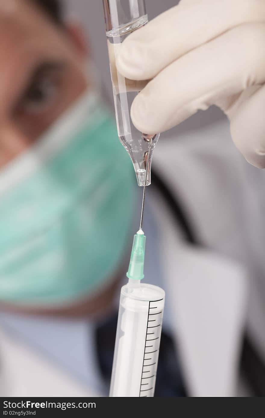 Doctor With Medical Syringe In Hands