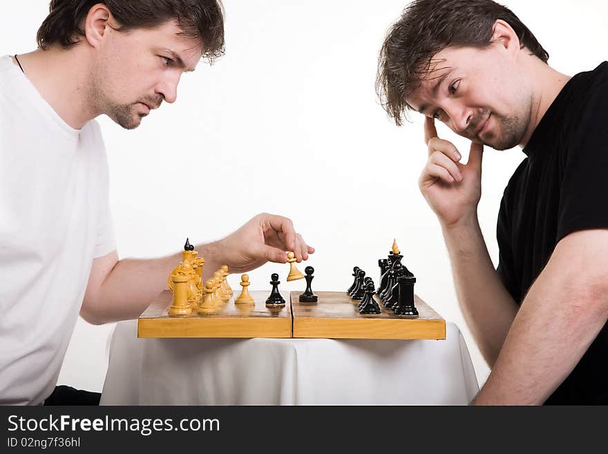 Two men play a chess