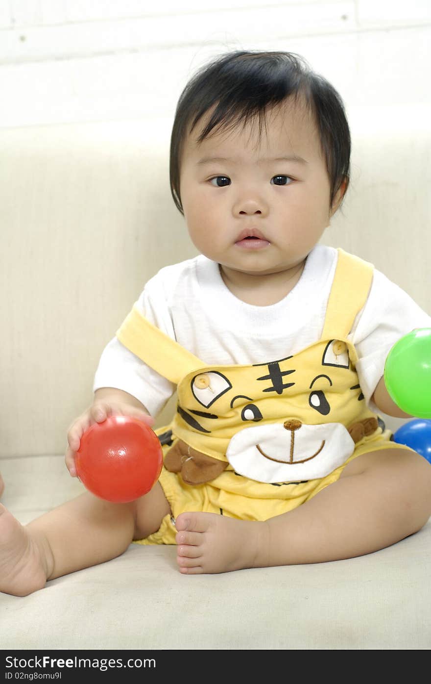 Small girl looking up with toys. Small girl looking up with toys