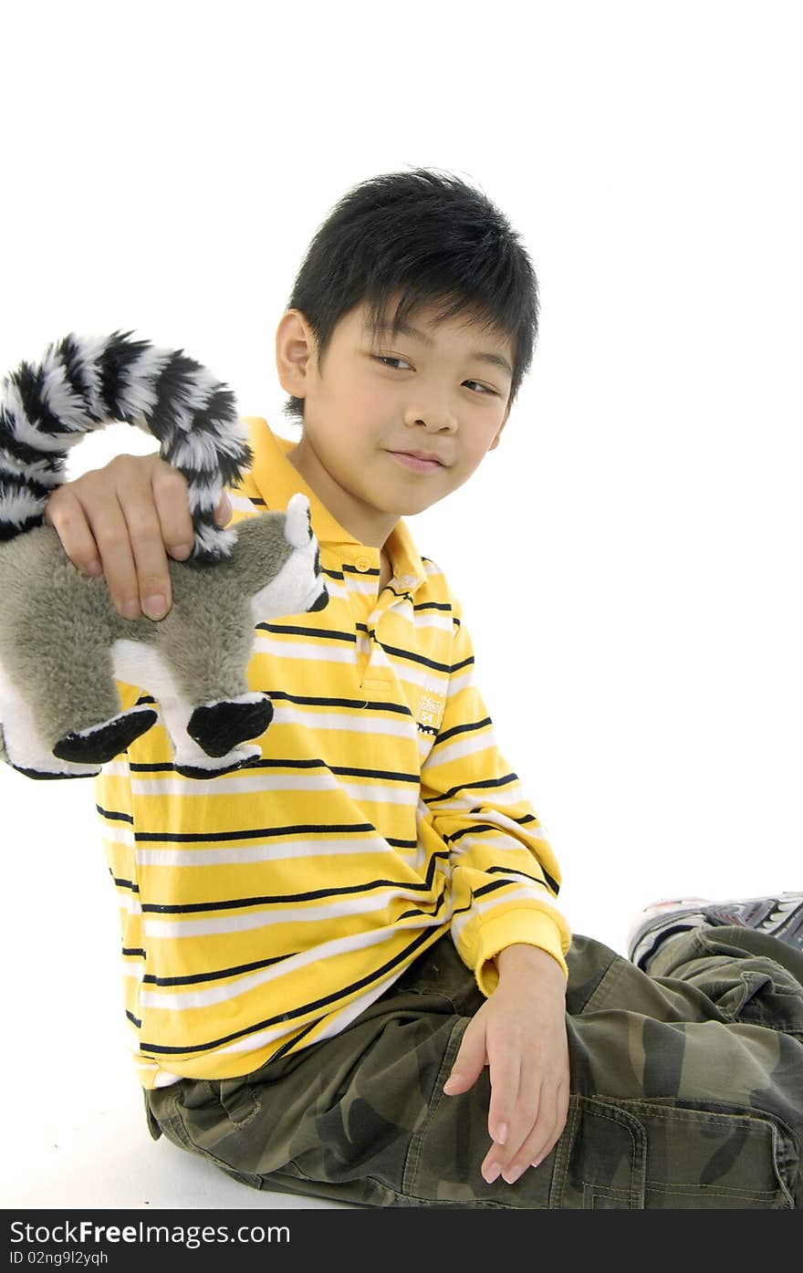 Photo of Asian kid with lemur toy. Photo of Asian kid with lemur toy