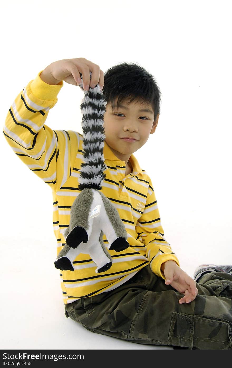 Photo of Asian kid with lemur toy. Photo of Asian kid with lemur toy