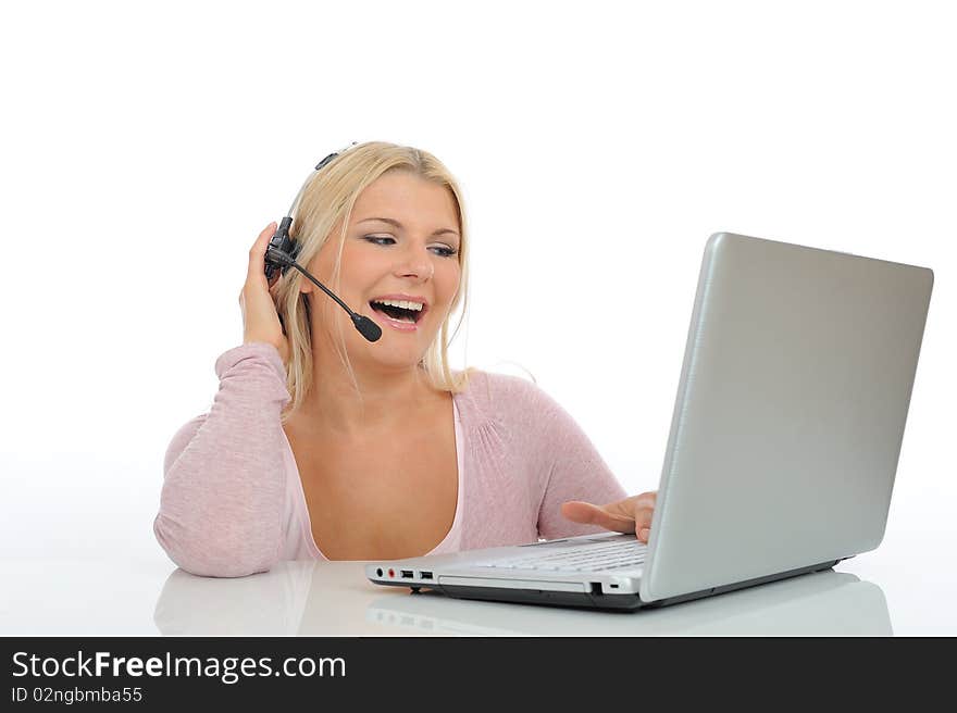 Young woman with microphone and computer having online conversation throw internet. help desk assistant