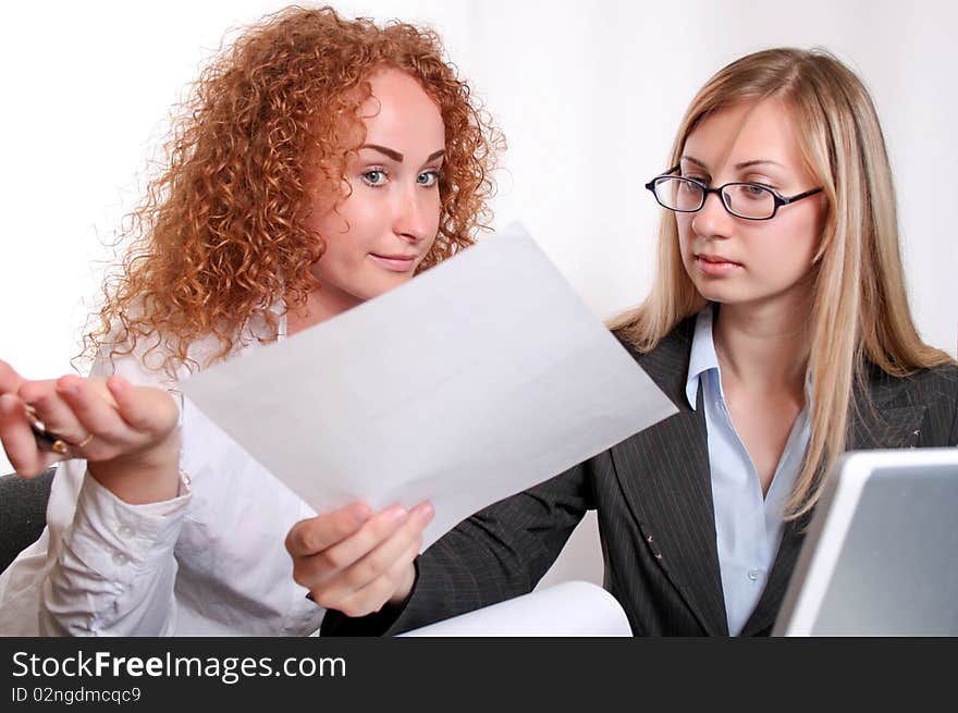 Young smiling business woman working and consulting a partner. Young smiling business woman working and consulting a partner