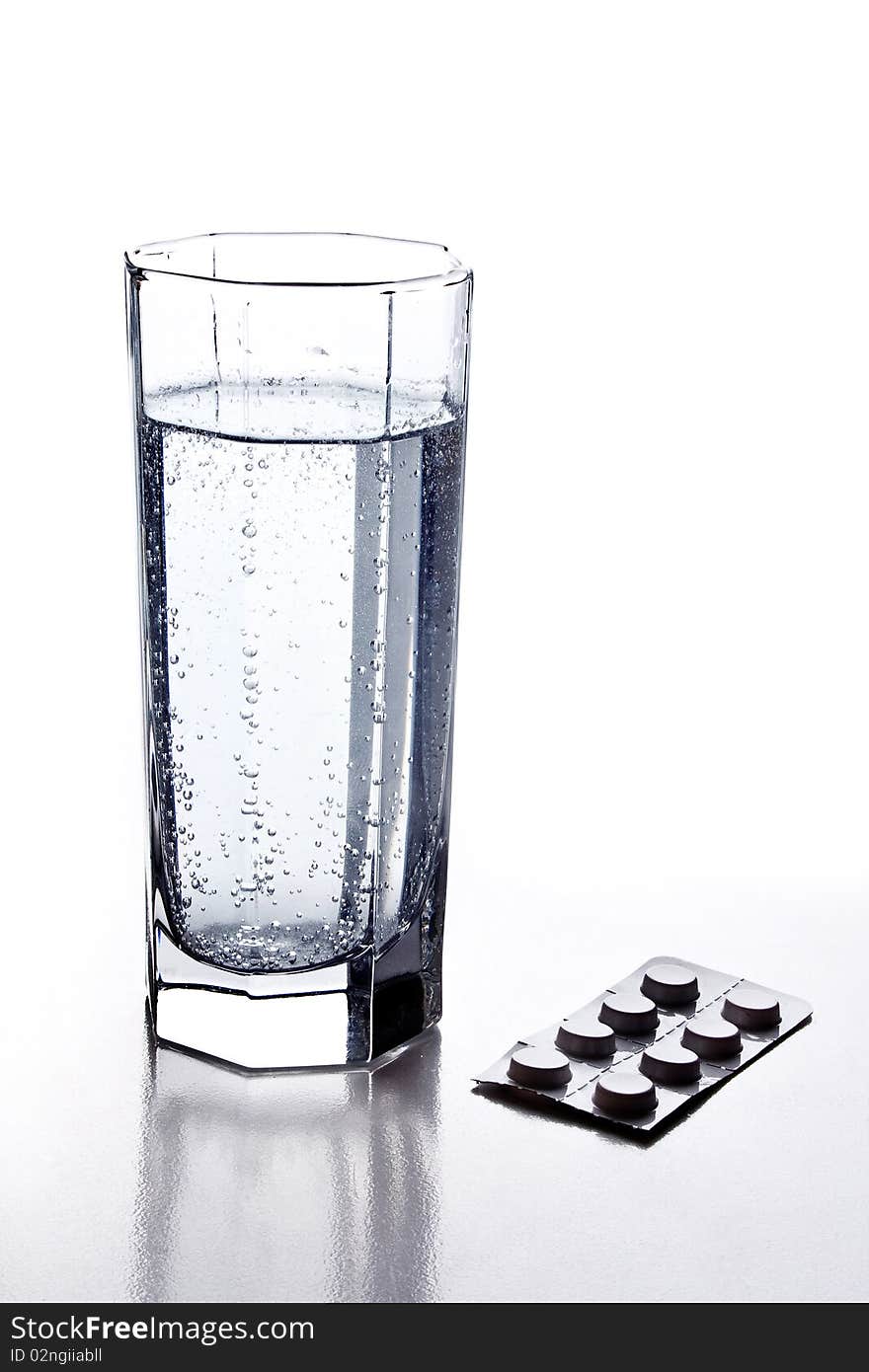 Glass of soda and pill on white background. Glass of soda and pill on white background