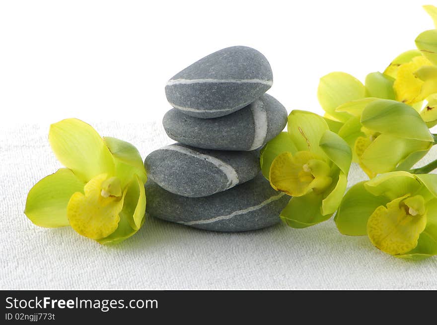 Spa essentials pyramid of stones with orchid. Spa essentials pyramid of stones with orchid